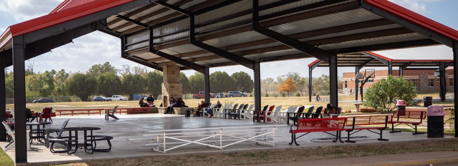 Outdoor area to relax with benches under very large pavilion.