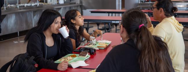 students eating a meal in the school cafeteria together